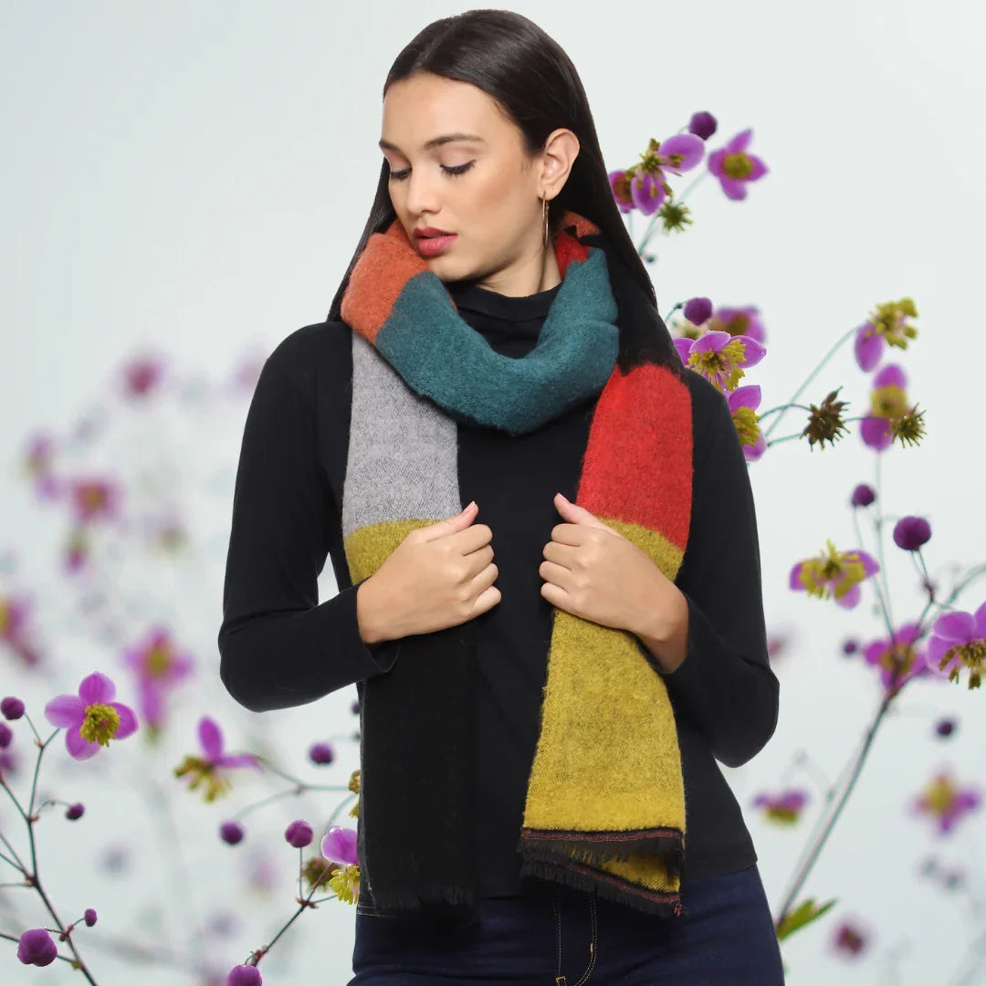 Woman outdoors wearing a Kashmiri shawl with vibrant floral embroidery and beige base