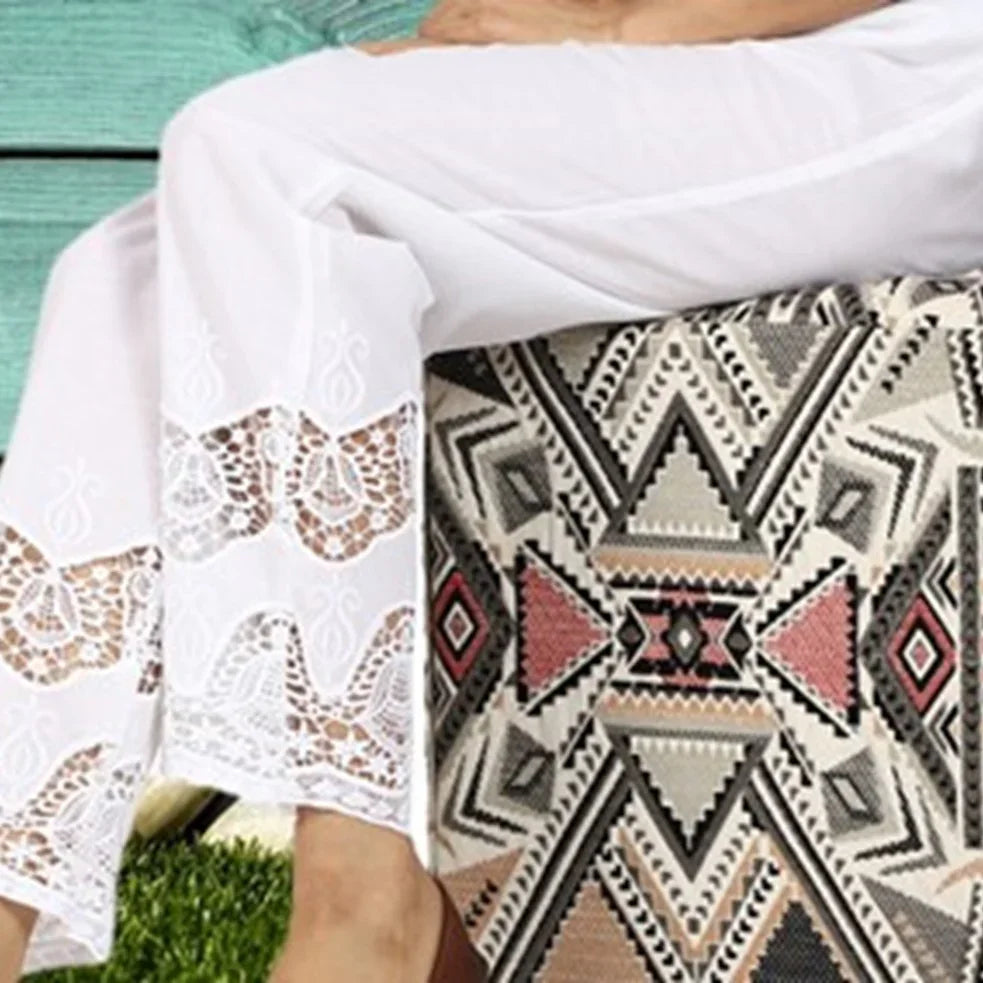 Woman outdoors wearing a Kashmiri shawl with vibrant floral embroidery and beige base