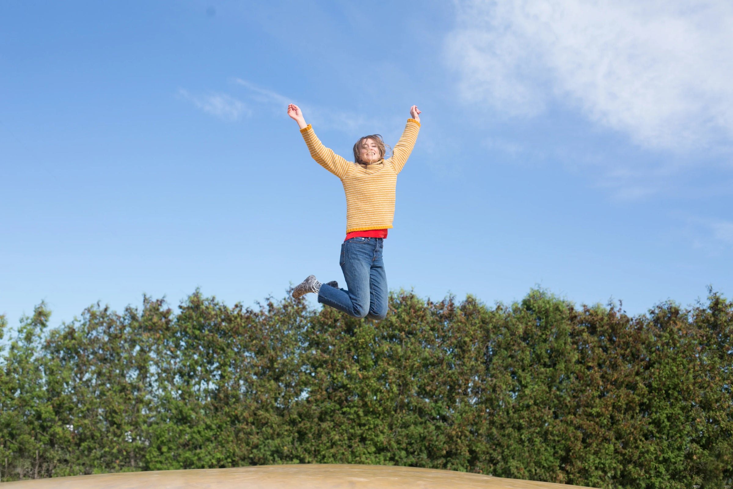 happy-woman-jumps-on-trampoline